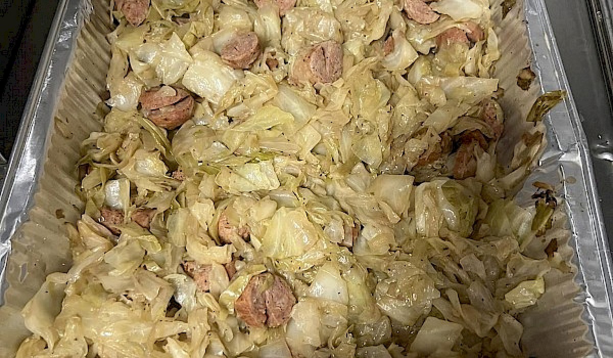 sausage and cabbage in a large roasting tin