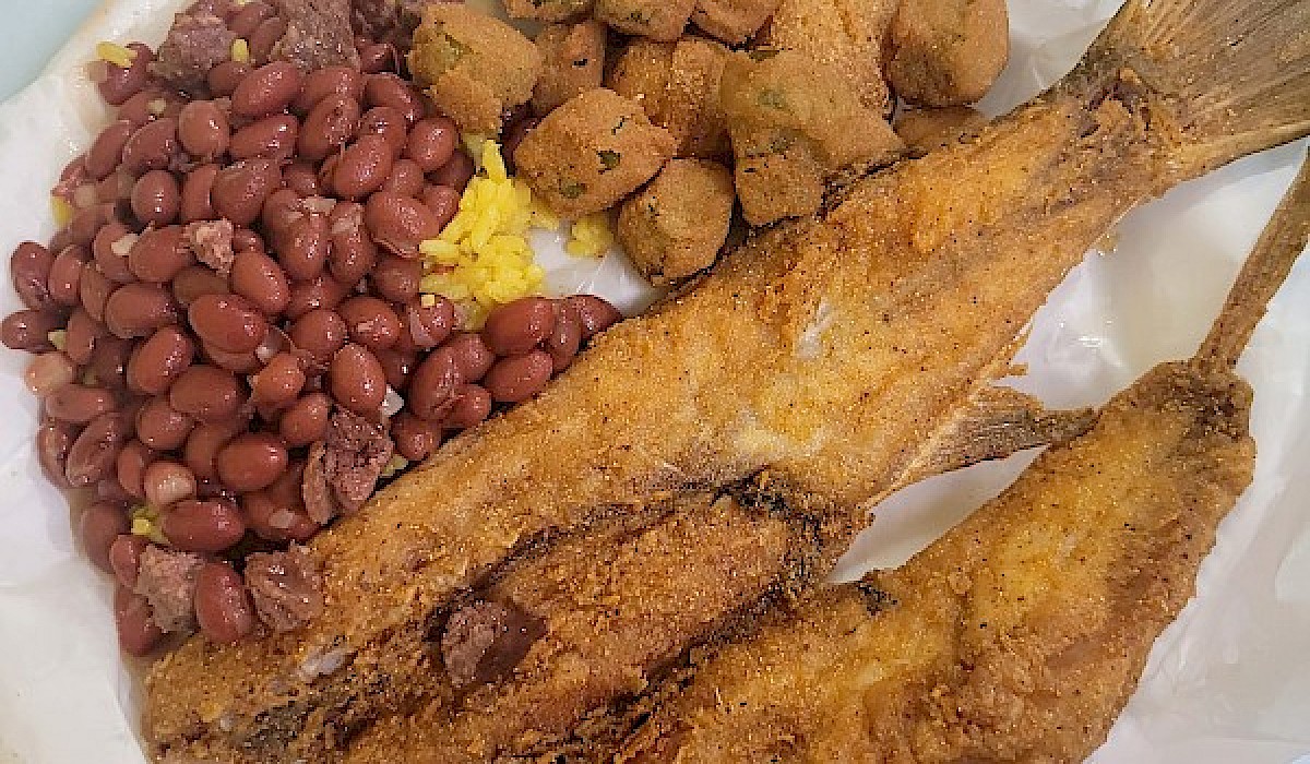 fried fish platter with beans and fried okra at a restaurant