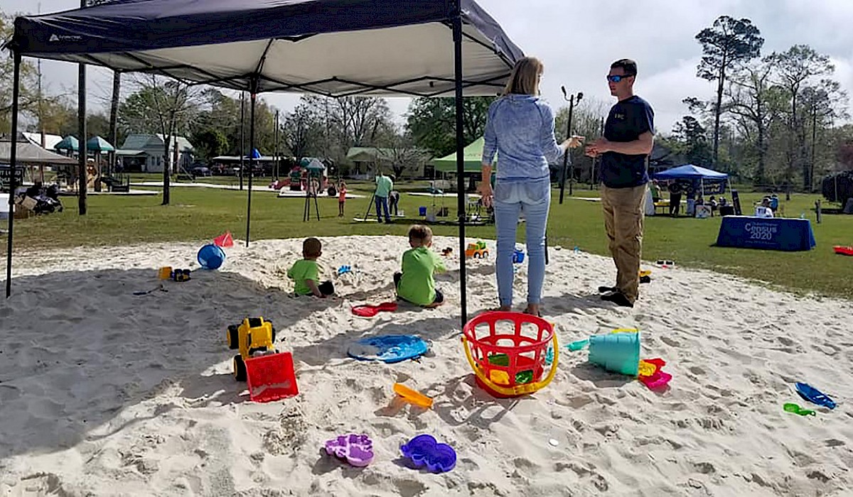 sand pit with children playing with sand toys
